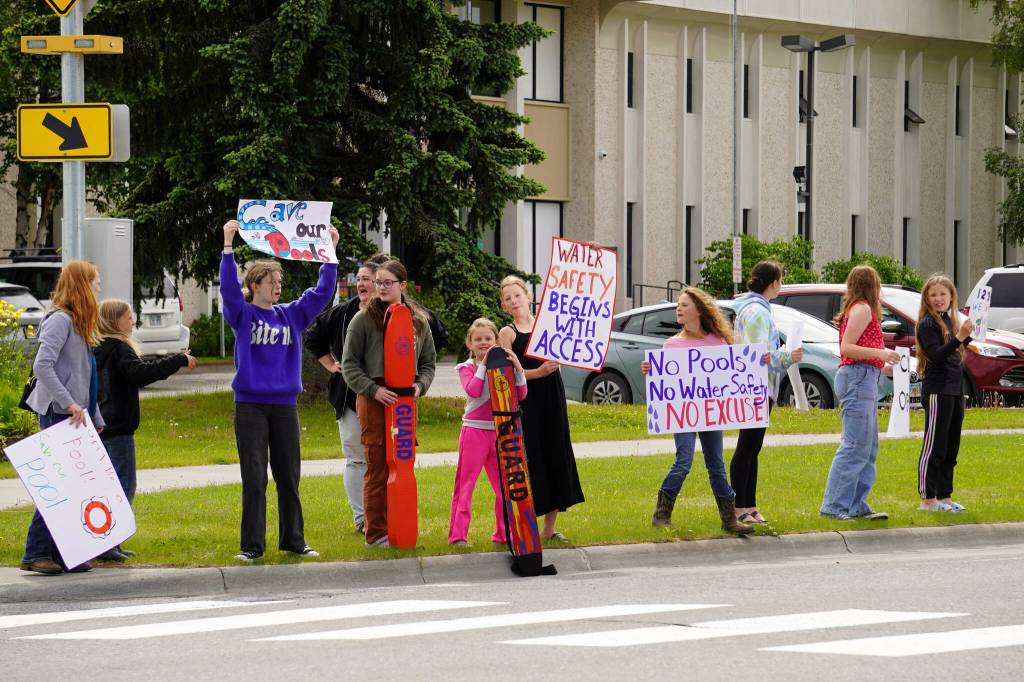 Swimmers and parents protest the proposed closure of Kenai Peninsula Borough School District pools outside of the Kenai Peninsula Borough Administration Building in Soldotna on Thursday. (Jake Dye/Peninsula Clarion)