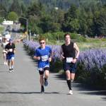 Charlie Rustand and Landon Tinsley run along the Homer Spit Trail during the Homer Spit Run 10K to the Bay on Saturday, June 28, 2025, in Homer, Alaska. (Delcenia Cosman/Homer News)