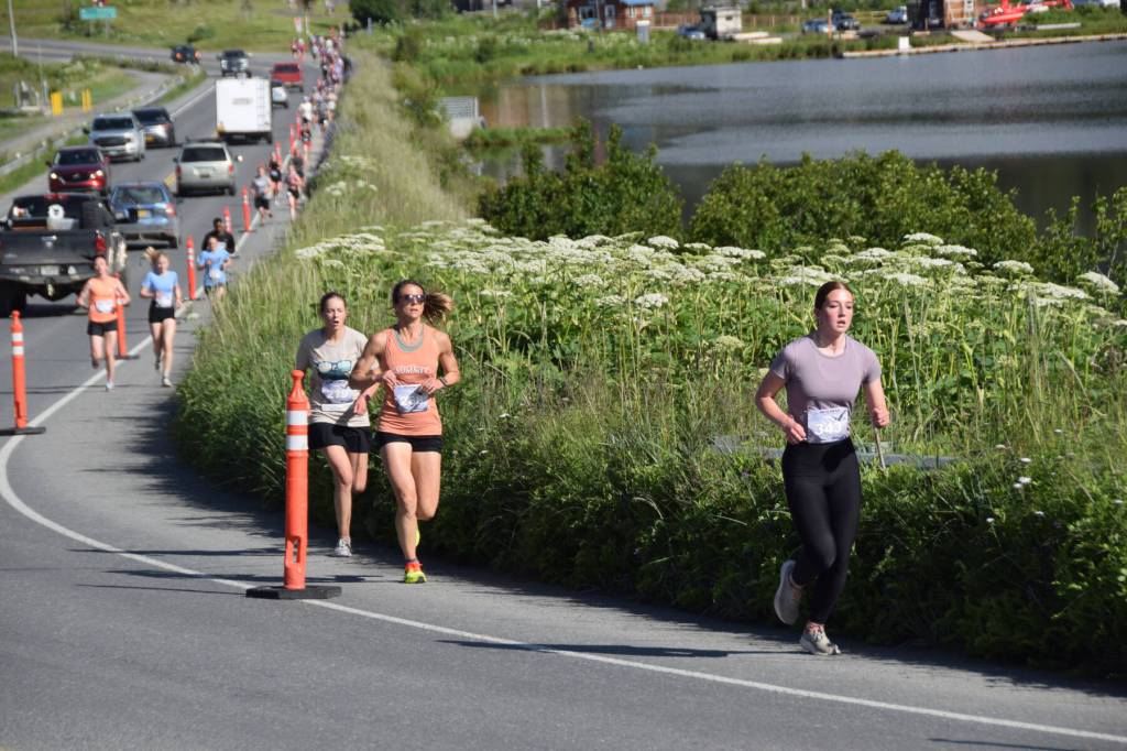 Runners participating in the Homer Spit Run 10K to the Bay on Saturday, June 28, 2025, run along Ocean Drive toward the finish line at Lands End Resort in Homer, Alaska. (Delcenia Cosman/Homer News)