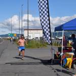 Michael Shearer crosses the finish line near Lands End Resort, taking first place in the mens category for the Cosmic Hamlet Half Marathon on Saturday, June 28, 2025, in Homer, Alaska. (Delcenia Cosman/Homer News)