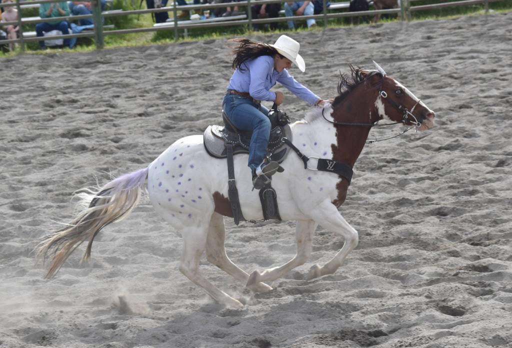 Homers Jade Jones, with her horse keeping to the purple theme of the rodeo, competes in Open Barrels on Saturday, June 28, 2025, in the second Soldotna Equestrian Association rodeo of the year at the Soldotna Rodeo Grounds in Soldotna, Alaska. (Photo by Jeff Helminiak/Peninsula Clarion)