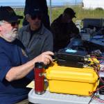 South Peninsula Amateur Radio Club member Toby Reich and club president Rick Baird operate a ham radio during a nationwide contest on Saturday, June 28, 2025, on the Homer Spit in Homer, Alaska. (Delcenia Cosman/Homer News)