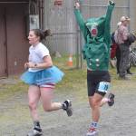 Allison Barnwell, 33, of Wenatchee, Washington, carries on the tradition of the Gumby costume during the womens race at the Mount Marathon Race on July 4, 2025, in Seward, Alaska. (Photo by Jeff Helminiak/Peninsula Clarion)