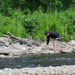 Ruth Mitchell collects stranded ducks during the annual Anchor River Duck Races on Saturday, July 5, 2025, in Anchor Point, Alaska. (Delcenia Cosman/Homer News)