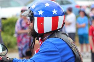 A participant in the 2019 July Fourth parade, hosted by the Homer Chamber of Commerce, rides his motorcycle down Pioneer Avenue.