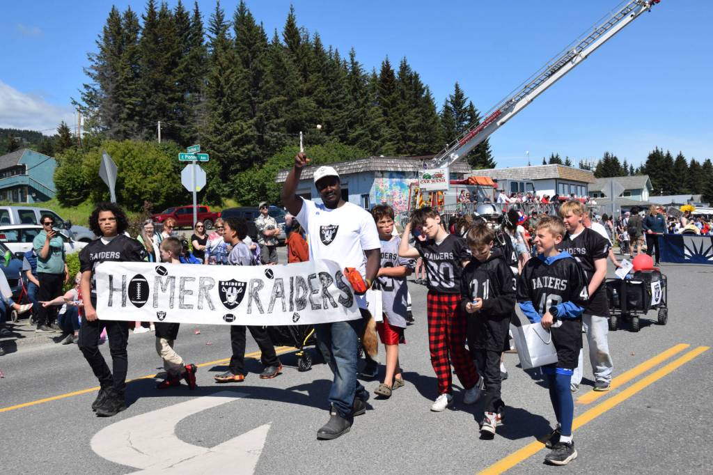 Homer Raiders Pop Warner football players march down Pioneer Avenue during the Fourth of July parade on Friday, July 4, 2025, in Homer, Alaska. (Delcenia Cosman/Homer News)