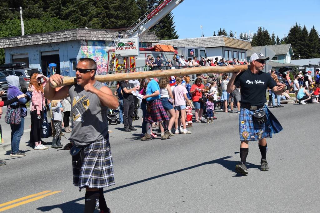 Members of the Kachemak Bay Scottish Club march down Pioneer Avenue, carrying a caber during the Fourth of July parade on Friday, July 4, 2025, in Homer, Alaska. The annual Kachemak Bay Highland Games were held on Saturday, July 5. (Delcenia Cosman/Homer News)