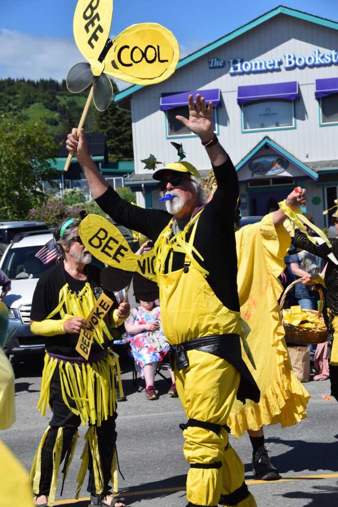 Community members in the Bee the Change group dance in front of the Bay Realty judging station during the Fourth of July parade on Friday, July 4, 2025, in Homer, Alaska. (Delcenia Cosman/Homer News)