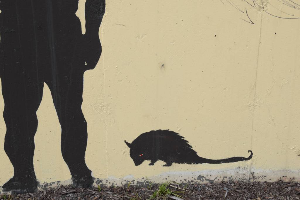 Grubby stares out from a corner of the mural on July 2. She was added to the mural by Reed in 2024, after a vandal snuck a sticker of the unofficial, beloved Homer mascot on the wall. (Chloe Pleznac/Homer News)