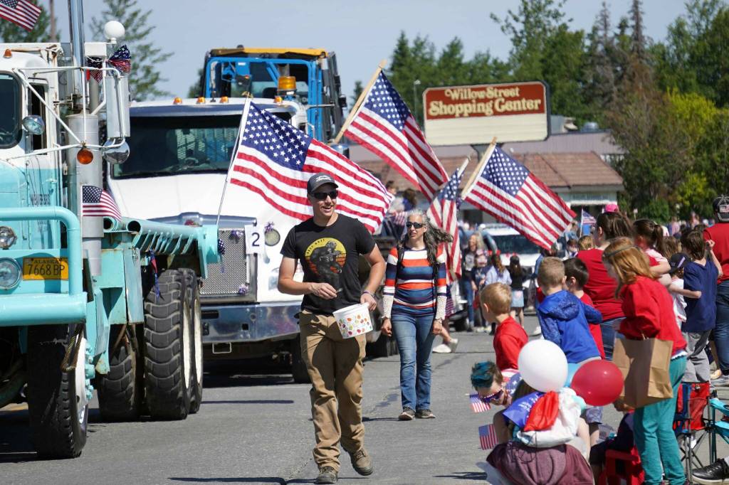 Children leap forward to grab candy during a Fourth of July parade on South Willow Street in Kenai, Alaska, on July 4, 2025. (Photo courtesy Sarah Every)