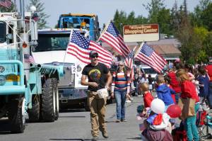 Children leap forward to grab candy during a Fourth of July parade on South Willow Street in Kenai, Alaska, on July 4, 2025. (Photo courtesy Sarah Every)