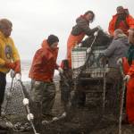 A group of fishers pack away a set beach seine during a test fishery for the gear near Clam Gulch, Alaska, on Wednesday, July 9, 2025. (Jake Dye/Peninsula Clarion)