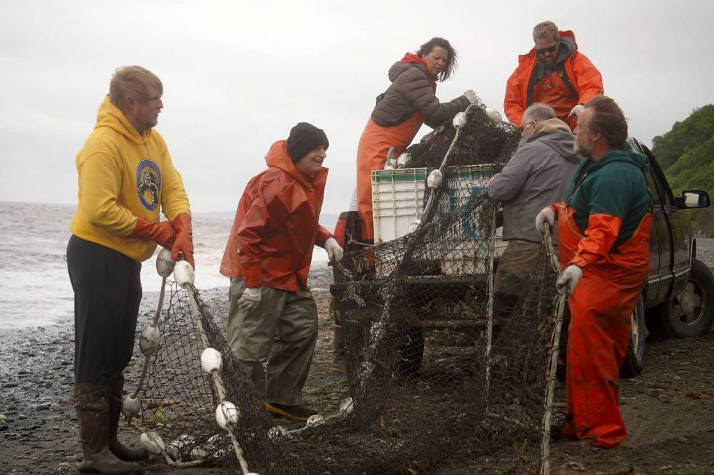 A group of fishers pack away a set beach seine during a test fishery for the gear near Clam Gulch, Alaska, on Wednesday, July 9, 2025. (Jake Dye/Peninsula Clarion)