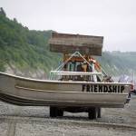 Brent Johnson carries his drift boat up the beach during a test fishery for set beach seines near Clam Gulch, Alaska, on Wednesday, July 9, 2025. (Jake Dye/Peninsula Clarion)