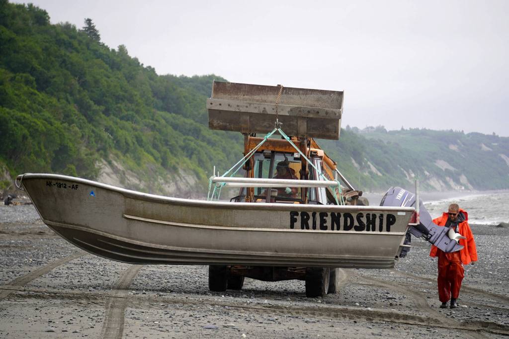 Brent Johnson carries his drift boat up the beach during a test fishery for set beach seines near Clam Gulch, Alaska, on Wednesday, July 9, 2025. (Jake Dye/Peninsula Clarion)