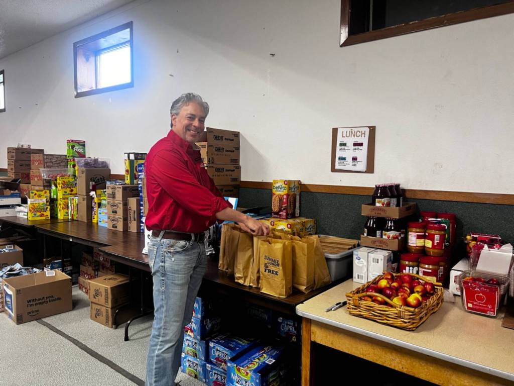 Leading Knight John Mink poses for a picture while assembling lunch bags at Glacierview Baptist Churchs Third Annual Kids Free Summer Lunch Program. (Photo courtesy of Jill Hockema)
