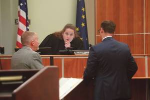 Attorneys Eric Derleth and Dan Strigle speak to Superior Court Judge Kelly Lawson during the opening arguments of State of Alaska v. Nathan Erfurth at the Kenai Courthouse on Wednesday. (Jake Dye/Peninsula Clarion)