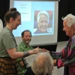 Homer Chamber of Commerce Visitor Center Director Jan Knutson (right) accepts the Art Advocate award at  Homer Council on the Arts' annual Community Arts Award Ceremony on Saturday, July 19, 2025, in Homer, Alaska. (Delcenia Cosman/Homer News)