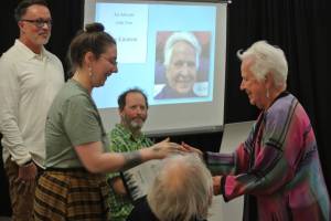 Homer Chamber of Commerce Visitor Center Director Jan Knutson (right) accepts the Art Advocate award at  Homer Council on the Arts' annual Community Arts Award Ceremony on Saturday, July 19, 2025, in Homer, Alaska. (Delcenia Cosman/Homer News)