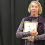 Jill Berryman speaks after being awarded the Mary Epperson Lifetime Achievement Award at Homer Council on the Arts annual Community Arts Award Ceremony on Saturday, July 19, 2025, in Homer, Alaska. (Delcenia Cosman/Homer News)