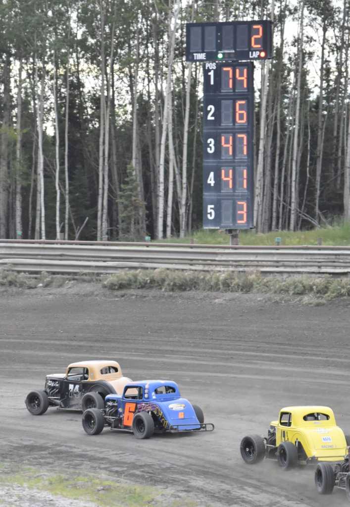 Parker Rose leads Brent Roumagoux on the way to winning the Legends feature at the Modified Dirty 30 on Saturday, July 19, 2025, at Twin City Raceway in Kenai, Alaska. (Photo by Jeff Helminiak/Peninsula Clarion)