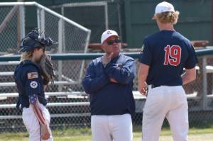 American Legion Post 20 Twins head coach Robb Quelland talks with catcher Ari Miller and pitcher Jacob Joanis during a game against West on Friday, June 13, 2025, at Coral Seymour Memorial Park in Kenai, Alaska. (Photo by Jeff Helminiak/Peninsula Clarion)