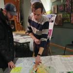 Attendees of the open house event for the draft 2035 comprehensive plan evaluate potential land use maps on Tuesday, Feb. 11, 2025, at the Alaska Maritime National Wildlife Refuge Visitor Center in Homer, Alaska. (Delcenia Cosman/Homer News)
