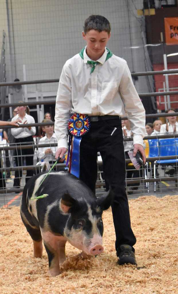 Samuel Merritt displays the Overall Grand Champion Market Hog at the Junior Market Livestock Auction at the Kenai Peninsula District 4-H Agriculture Expo on Saturday, July 27, 2025, at the Soldotna Regional Sports Complex in Soldotna, Alaska. (Photo by Jeff Helminiak/Peninsula Clarion)