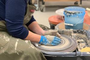 A community member works with clay on a wheel in the ceramics studio at Homer Council on the Arts in Homer, Alaska. Photo provided by Homer Council on the Arts