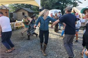 Concert-goers dance to music by Cousin Curtiss and Harrison B during Salmonfest on Sunday, Aug. 3, 2025, at the Headwaters Stage in the Kenai Peninsula Fairgrounds in Ninilchik, Alaska. (Delcenia Cosman/Homer News)