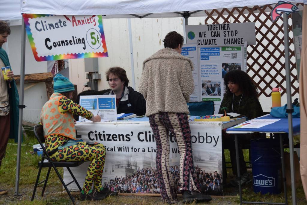 Salmonfest attendees visit booths in the Causeway, including the Citizens Climate Lobby, on Saturday, Aug. 2, 2025, at the Kenai Peninsula Fairgrounds in Ninilchik, Alaska. (Delcenia Cosman/Homer News)