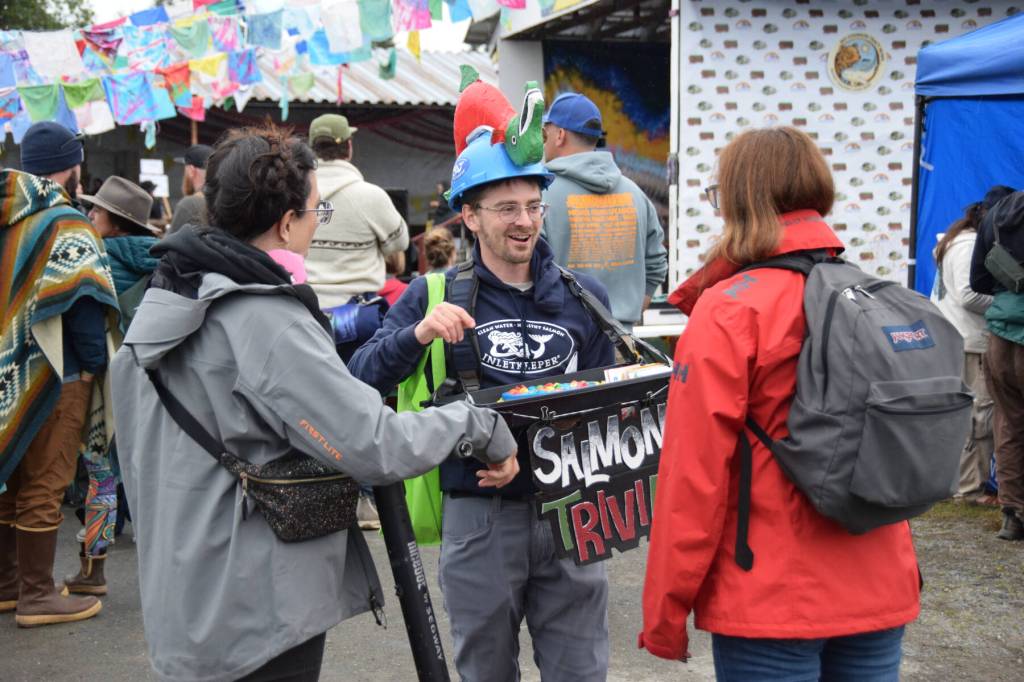 Cook Inletkeeper communications director (center) Jamie Currie shares salmon trivia with Salmonfest attendees in the Causeway on Saturday, Aug. 2, 2025, at the Kenai Peninsula Fairgrounds in Ninilchik, Alaska. (Delcenia Cosman/Homer News)