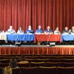 The Kenai Peninsula Borough Assembly gathers before the beginning fo the Aug. 5, 2025, KPB Assembly meeting at the Porcupine Theater in Homer, Alaska. (Chloe Pleznac/Homer News)