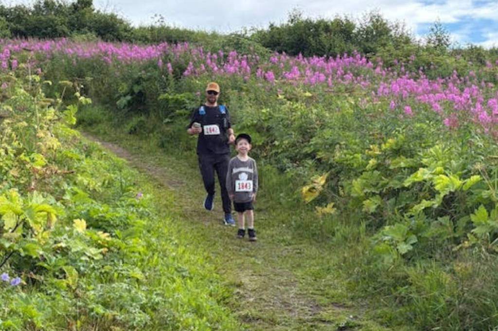 Kyle Settles and Jack Settles run along the trail at Eveline State Recreation Site on Saturday, Aug. 9, 2025, during the inaugural 5K hosted by Kachemak Bay Running Club. (Photo courtesy of Michael Murray)