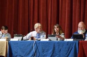 Kenai Peninsula Borough Assembly president, Peter Ribbens, speaks in an aside to District 8 representative and Vice President Kelly Cooper before the beginning of the Aug. 5, 2025, KPB Assembly meeting at the Porcupine Theater in Homer, Alaska. (Chloe Pleznac/Homer News)