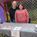 Presley-Riven Willden (right) and Mailea Willden sell painted rocks and other handicrafts at the Homer Farmers Market on Kids Vending Day on Wednesday, Aug. 13, 2025, in Homer, Alaska. (Delcenia Cosman/Homer News)