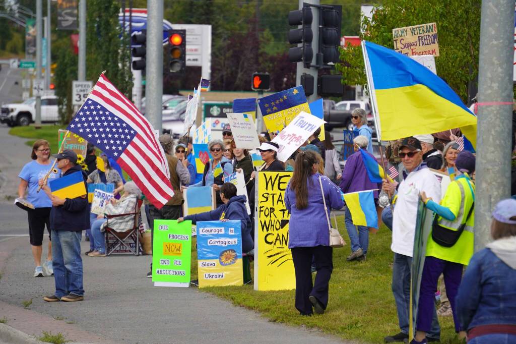 Protesters in support of Ukraine line the Sterling Highway in Soldotna, Alaska, on Friday, Aug. 15, 2025. (Jake Dye/Peninsula Clarion)