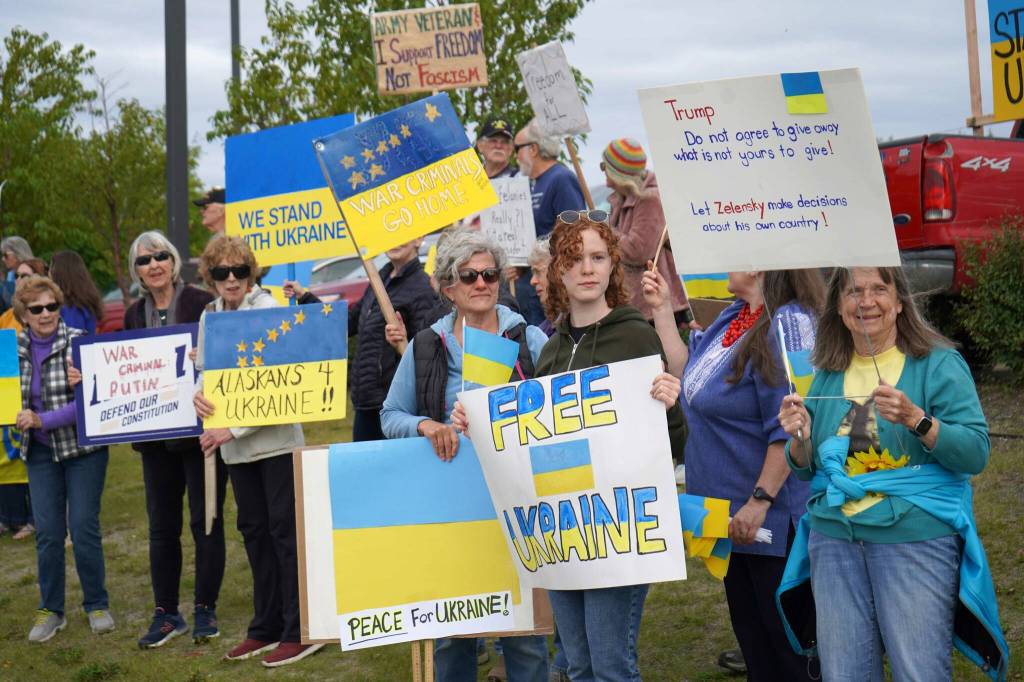 Protesters in support of Ukraine line the Sterling Highway in Soldotna, Alaska, on Friday, Aug. 15, 2025. (Jake Dye/Peninsula Clarion)