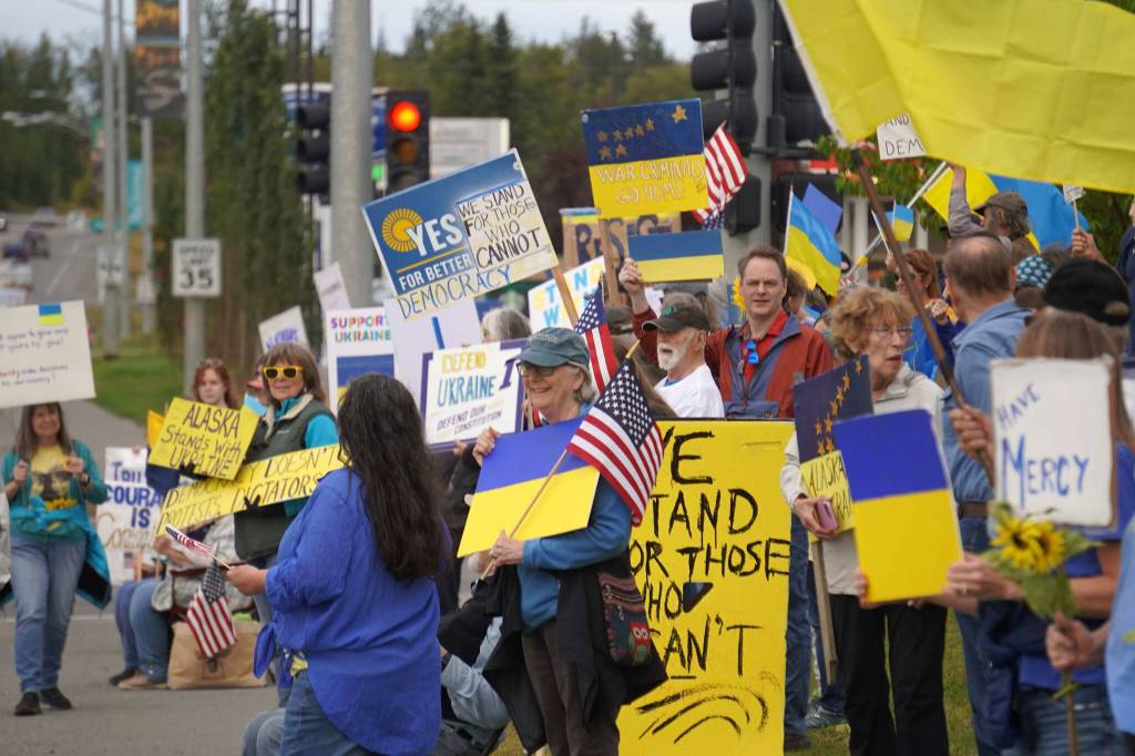 Protesters in support of Ukraine line the Sterling Highway in Soldotna, Alaska, on Friday, Aug. 15, 2025. (Jake Dye/Peninsula Clarion)