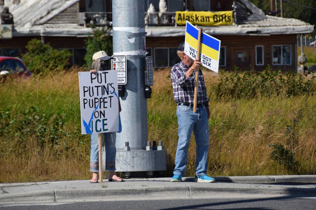 Protesters hold up signs expressing support for Ukraine on Friday, Aug. 15, 2025, in Homer, Alaska. (Delcenia Cosman/Homer News)