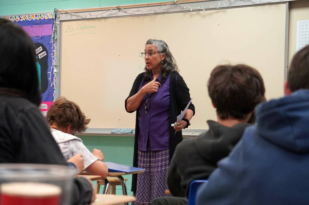 Lara Lindeman greets students on the first day of the 2025-2026 school year at Nikiski Middle/High School in Nikiski, Alaska, on Wednesday, Aug. 20, 2025. (Jake Dye/Peninsula Clarion)