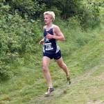 Soldotnas Ollie Dahl runs down a hill at the Ted McKenney XC Invitational on Saturday, Aug. 23, 2025, at Tsalteshi Trails just outside of Soldotna, Alaska. (Photo by Jeff Helminiak/Peninsula Clarion)