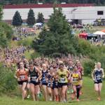 Service's Talia Smith leads the girls varsity pack near the start of the Ted McKenney XC Invitational on Saturday, Aug. 23, 2025, at Tsalteshi Trails just outside of Soldotna, Alaska. (Photo by Jeff Helminiak/Peninsula Clarion)
