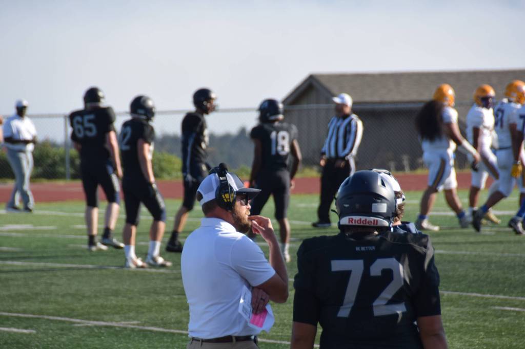 Homer High School Athletic Director and Head Coach, Justin Zank, listens to another coach. (Chloe Pleznac/Homer News)