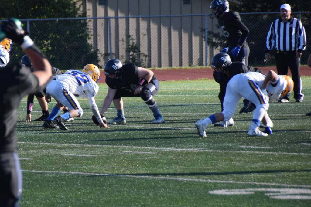 Barrows Jose Tuzroyluke faces off against Homers Timmy Cissney, backed by teammate David Webb. (Chloe Pleznac/Homer News)