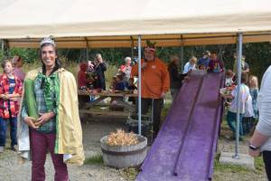 Former Zucchini Queen Christina Castellanos, owner and operator of Snowshoe Hollow Farm, prepares to lead the parade around the market during the annual Zucchini Festival on Saturday, Aug. 23, 2025, at the Homer Farmers Market in Homer, Alaska. (Delcenia Cosman/Homer News)
