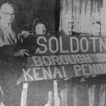 Soldotna was heavily promoted at the best location for the seat of government in the new Kenai Peninsula Borough. One of the key local promoters, seen in this old newspaper photo, was Dr. Paul Isaak (far left).