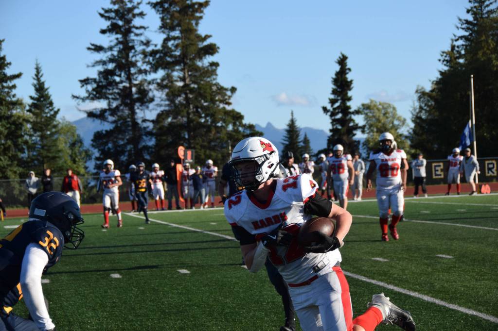 Jackson Snaric (32) goes to tackle the Kards Eli Smith (12) during the varsity game on Friday, Aug. 29, 2025, at the Homer High School football field in Homer, Alaska. (Delcenia Cosman/Homer News)