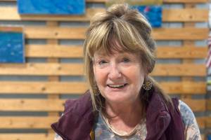 Artist Rosemary "Rozzi" Redmond shows a series of acrylic paintings with fishing themes at Grace Ridge Brewing in Homer, Alaska. The exhibit is open through September 2025. Photo by Christina Whiting