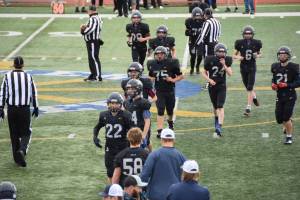Homer Mariner football players exit the field on Saturday, Sept. 13, ahead of the 2025 home game against Houston. (Chloe Pleznac/Homer News)